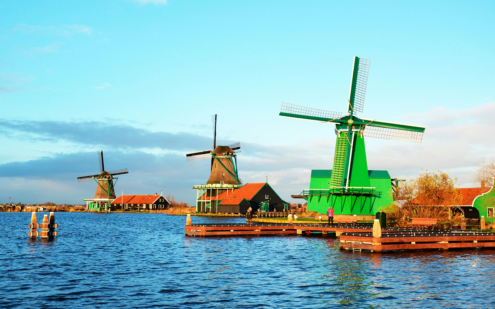 Windmills at Zaanse Schans by the water in the Netherlands.