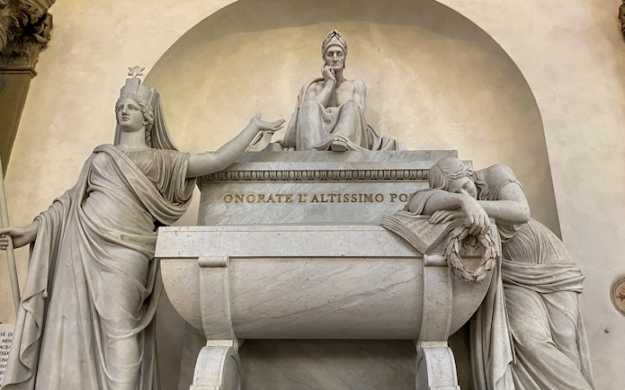 Santa Croce monument in Florence featuring statues and inscriptions.