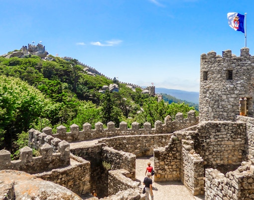 Walls of the Moorish Castle with Pena Palace in the background, Sintra, Portugal.