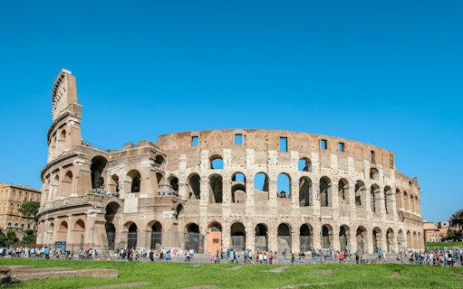 Colosseum exterior with tourists, Rome, Italy, featuring Gladiator’s Entrance and Arena Floor.