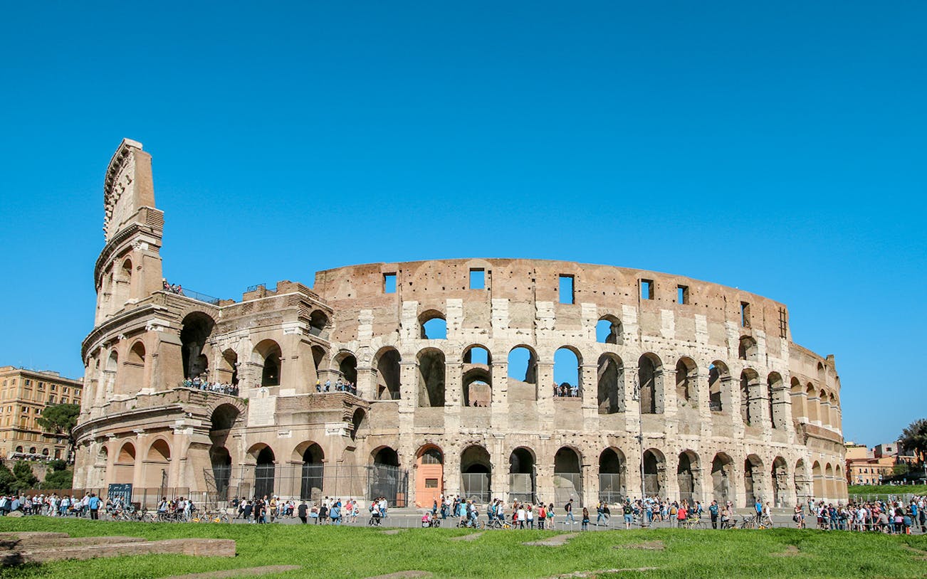 Colosseum exterior with tourists, Rome, Italy, featuring Gladiator’s Entrance and Arena Floor.