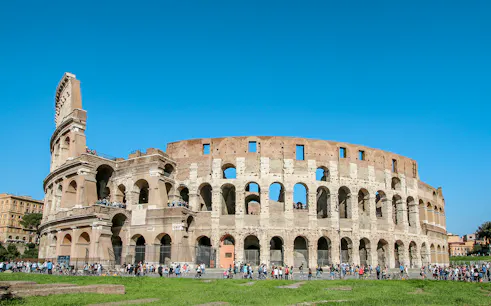 Colosseum exterior with tourists, Rome, Italy, featuring Gladiator’s Entrance and Arena Floor.