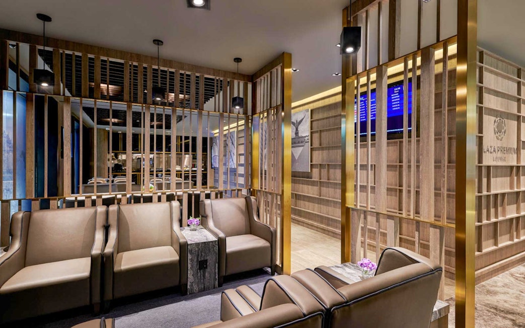 Plaza Premium Lounge seating area with modern decor and information screens.