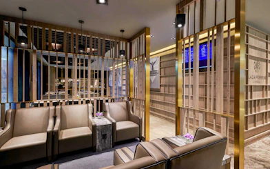 Plaza Premium Lounge seating area with modern decor and information screens.