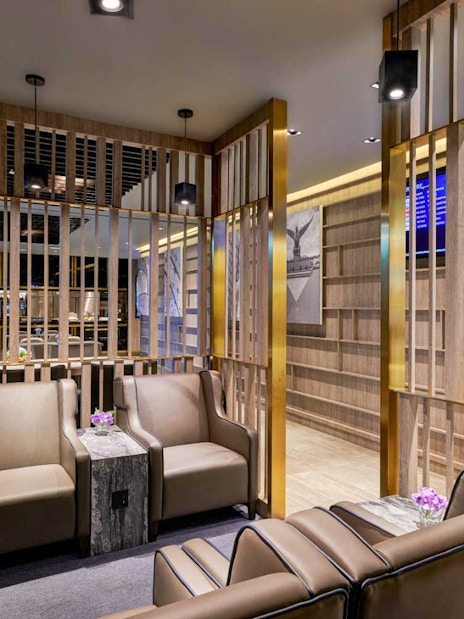 Plaza Premium Lounge seating area with modern decor and information screens.