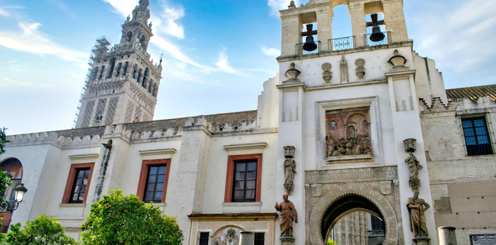 Puerta del Perdón and Giralda tower in Seville, Spain, showcasing intricate architecture.