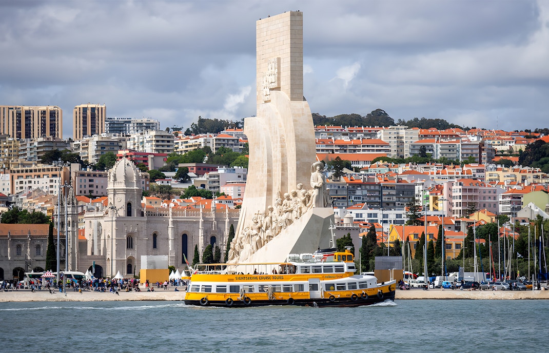 Lisbon river view with yellow hop-on hop-off boat, 24hr tour ticket experience.