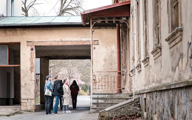 Group of people on a guided tour at Bohnice Psychiatric Hospital in Prague.