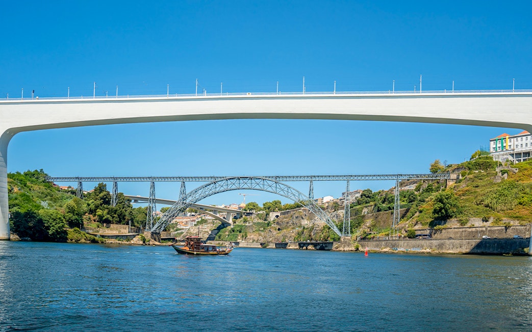 Ponte de São João and boat on Douro River during cruise in Porto, Portugal.