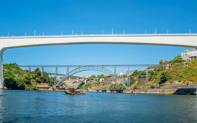Ponte de São João and boat on Douro River during cruise in Porto, Portugal.