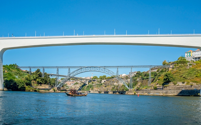 Ponte de São João and boat on Douro River during cruise in Porto, Portugal.