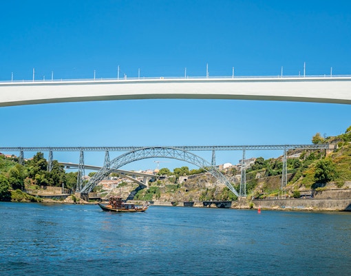 Ponte de São João and boat on Douro River during cruise in Porto, Portugal.