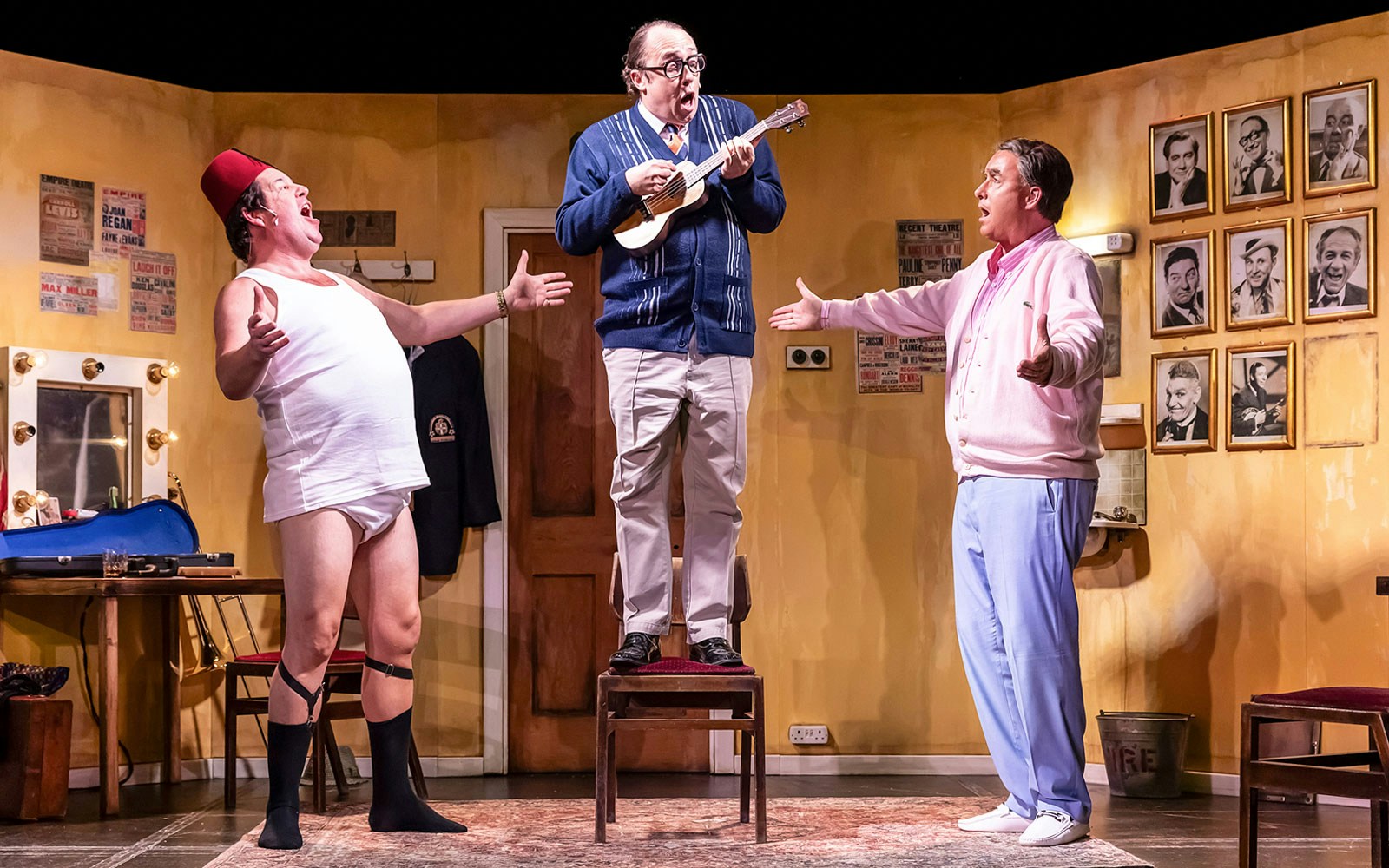 Three performers in a comedic scene from "The Last Laugh" on stage.