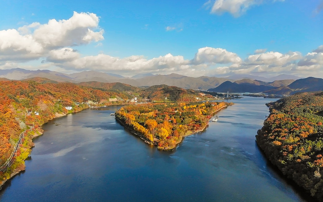 Aerial view of Nami Island in half-moon shape surrounded by autumn foliage, South Korea.
