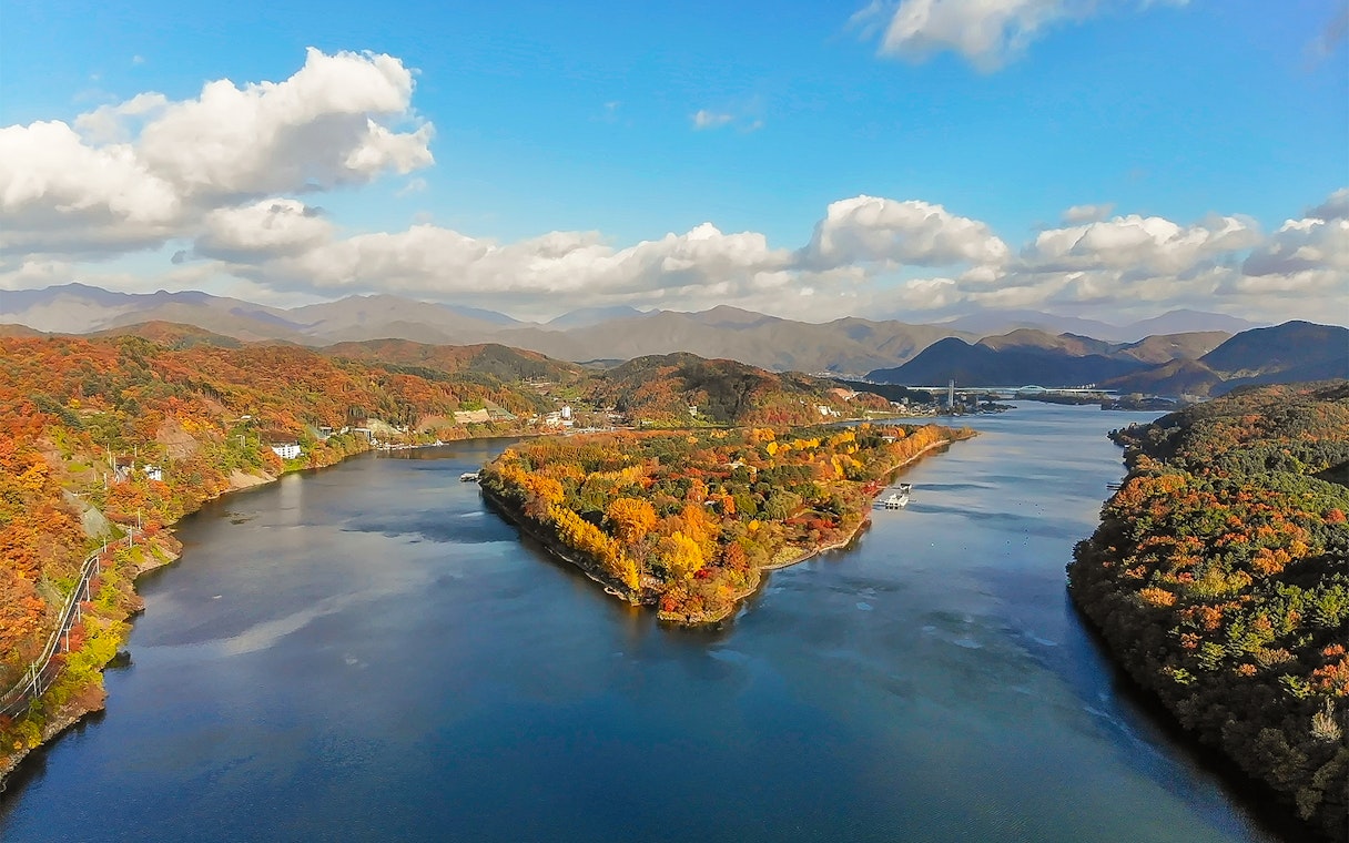 Aerial view of Nami Island in half-moon shape surrounded by autumn foliage, South Korea.