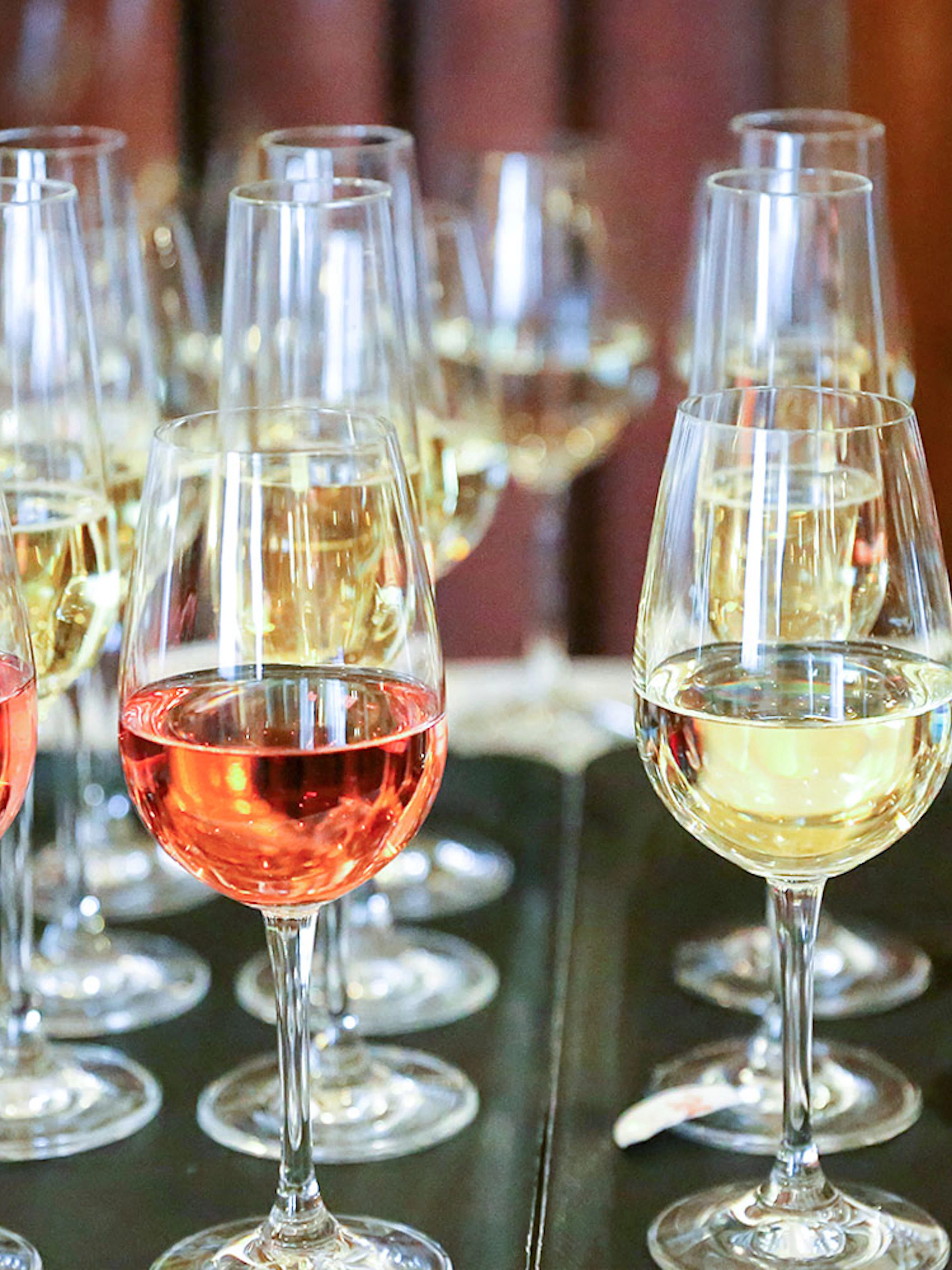 Glasses of red and white wine on a table during Mornington Peninsula winery tour.
