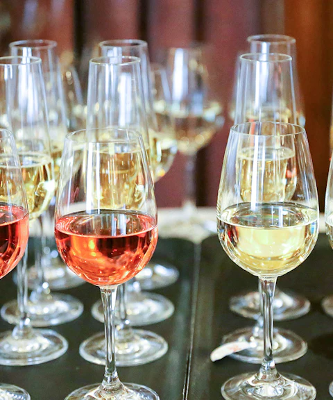 Glasses of red and white wine on a table during Mornington Peninsula winery tour.