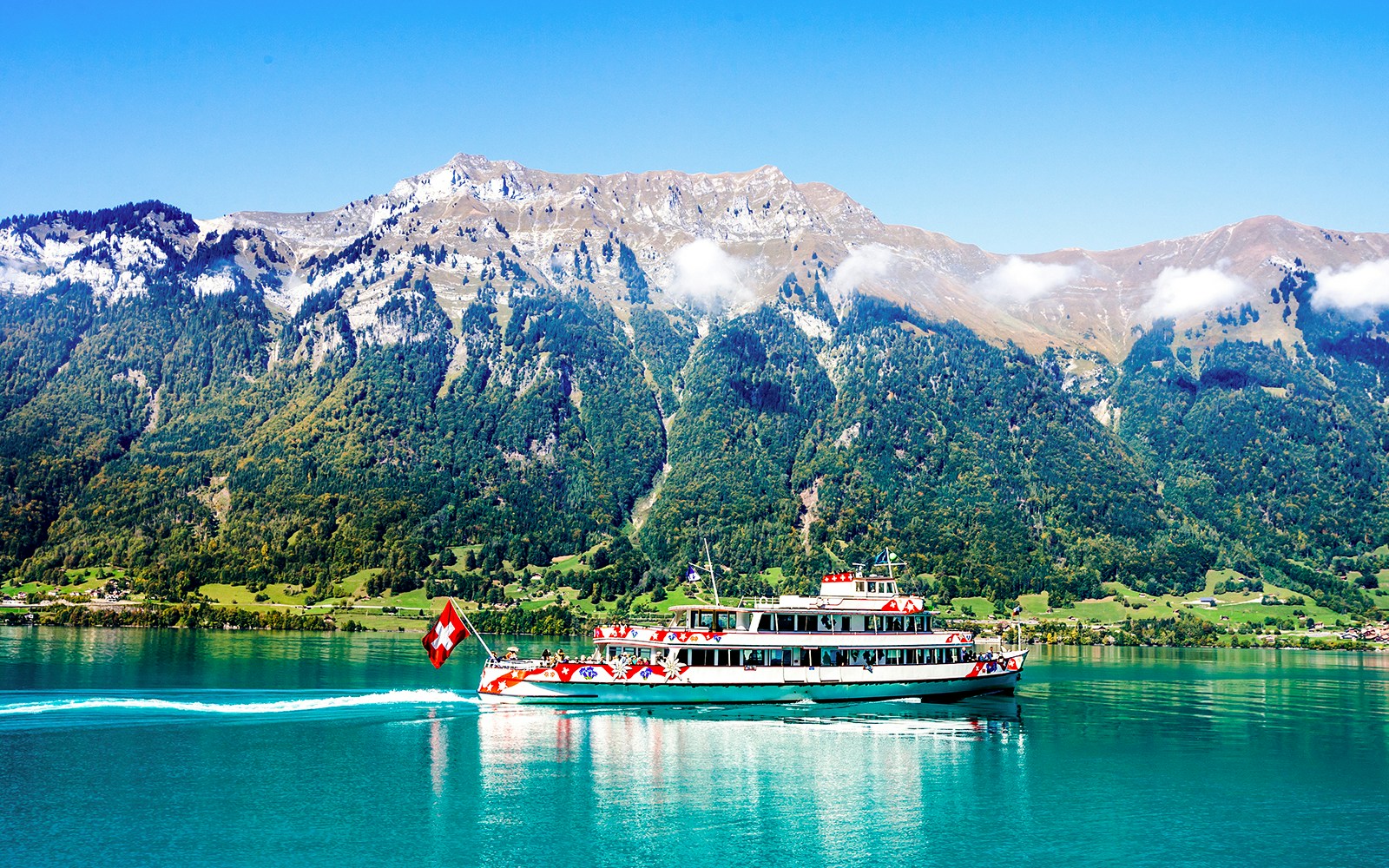 Boat cruise on Lake Thun with Swiss Alps and historic castles in Interlaken.