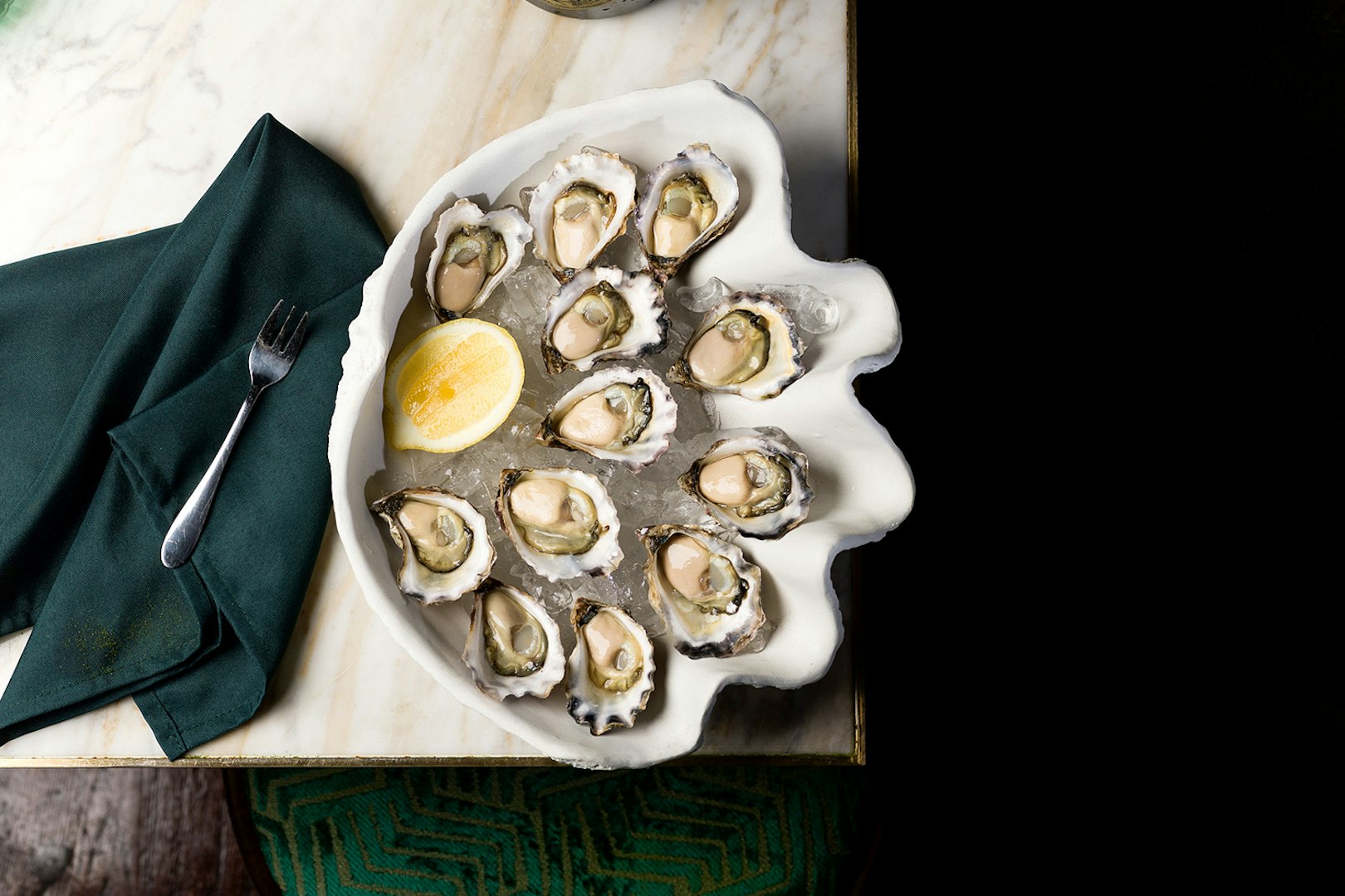 Plate of fresh oysters with lemon at The Emerald Room party.