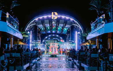 Night show on Dolphin cruise with performers on stage, Vietnam backdrop.