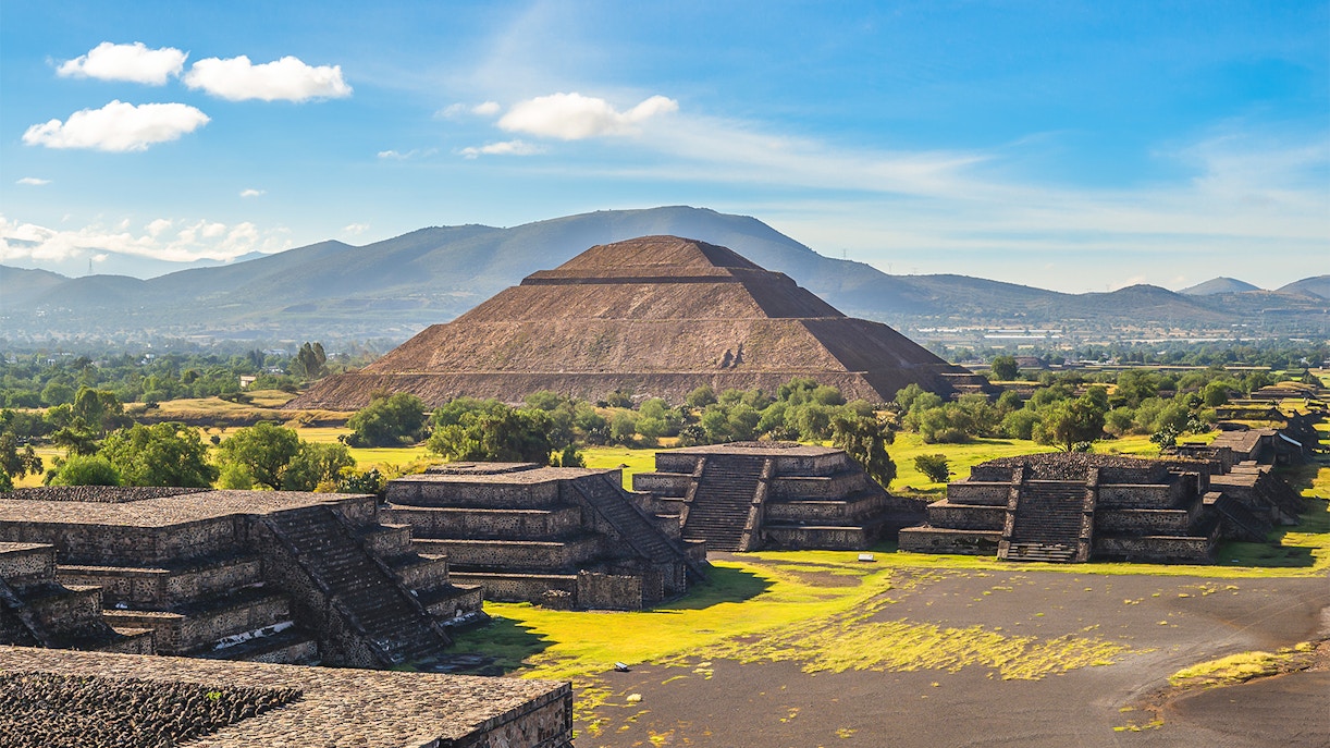 Pyramid of the Sun in Teotihuacan, Mexico, with tourists exploring the ancient site.
