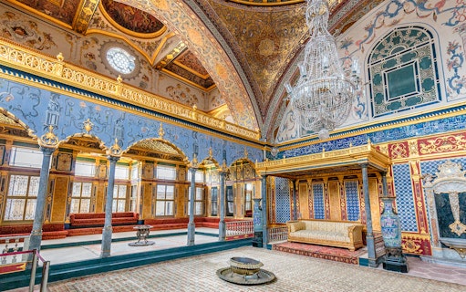 Topkapi Palace ornate interior with chandeliers and intricate wall designs, Istanbul.