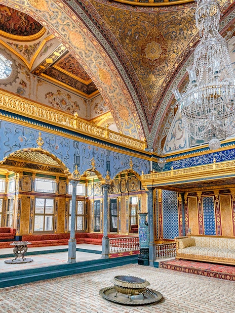 Topkapi Palace ornate interior with chandeliers and intricate wall designs, Istanbul.