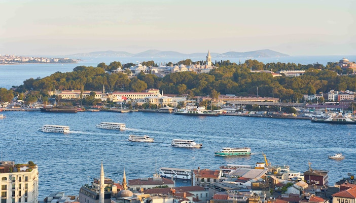 Bosphorus yacht cruising past Istanbul skyline with historic landmarks in view.