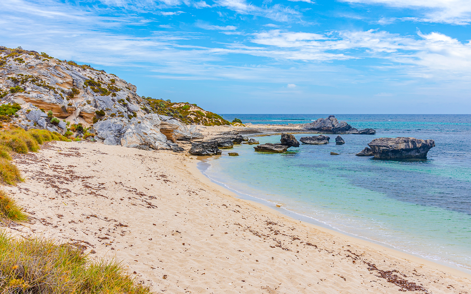 Sandy beach and rocky shoreline at City of York Bay, Rottnest Island, with clear blue water.