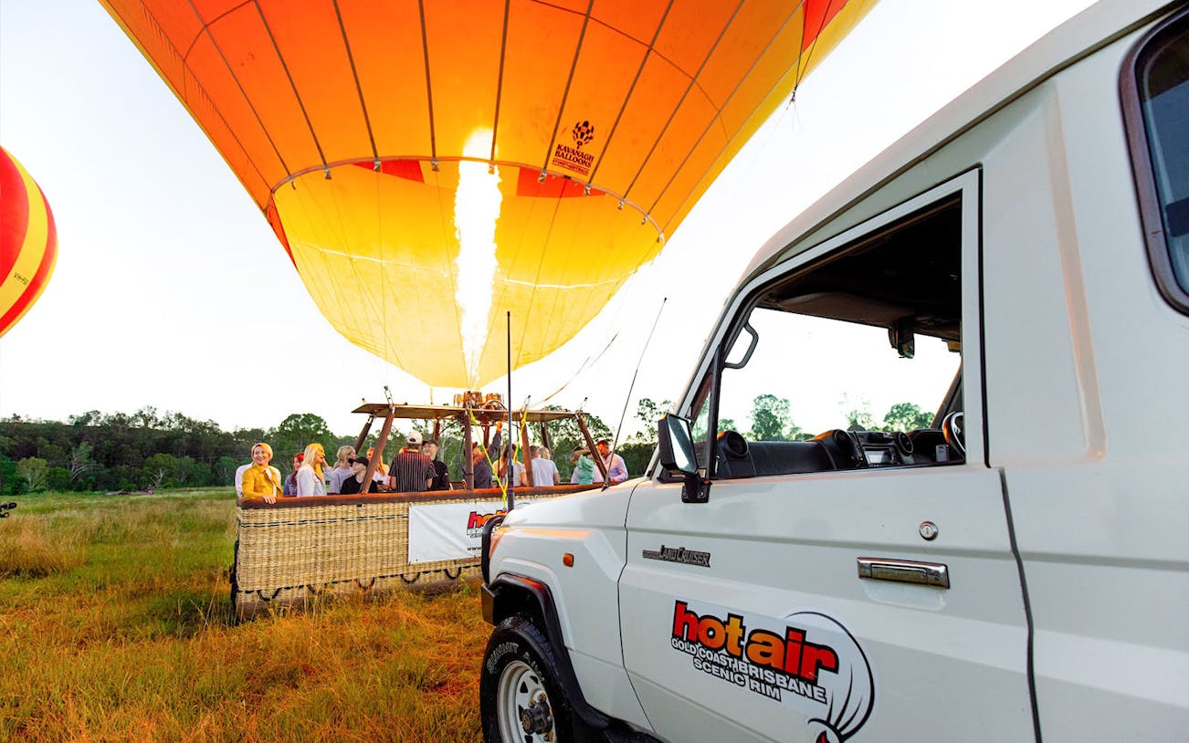 Hot air balloon preparing for flight in Brisbane with passengers boarding.
