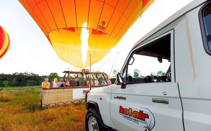 Hot air balloon preparing for flight in Brisbane with passengers boarding.