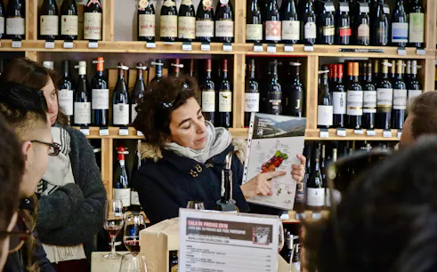 Bar tender showing tour group a map of Lisbon wineries during a food tour.