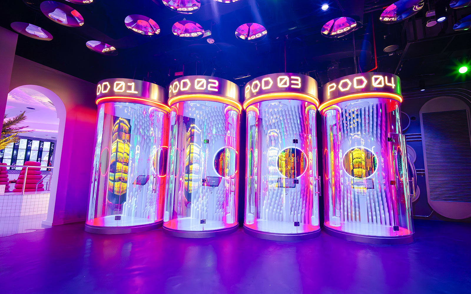 Interactive pods with neon lights at House of Hype, Dubai.