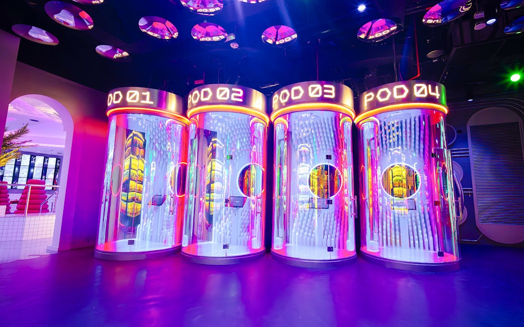 Interactive pods with neon lights at House of Hype, Dubai.