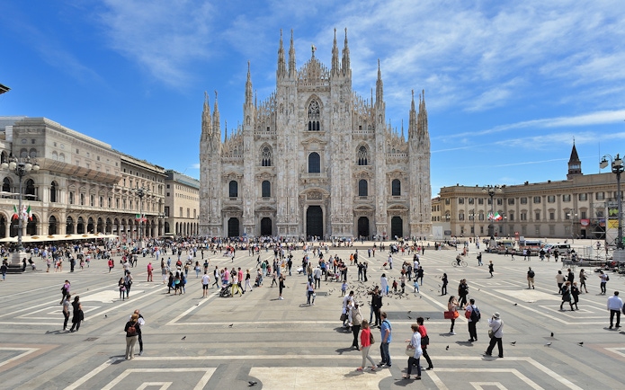 Guided tour group exploring Milan Cathedral facade.