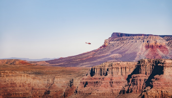 Helicopter flying over Grand Canyon West Rim, Arizona.