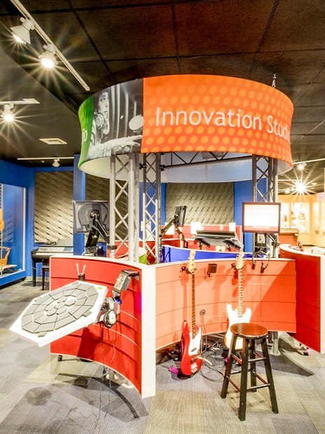 Innovation Studio with guitars and music equipment display in San Diego museum.