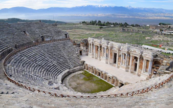 Hierapolis Ancient Theater in Pamukkale with stone seating and stage.