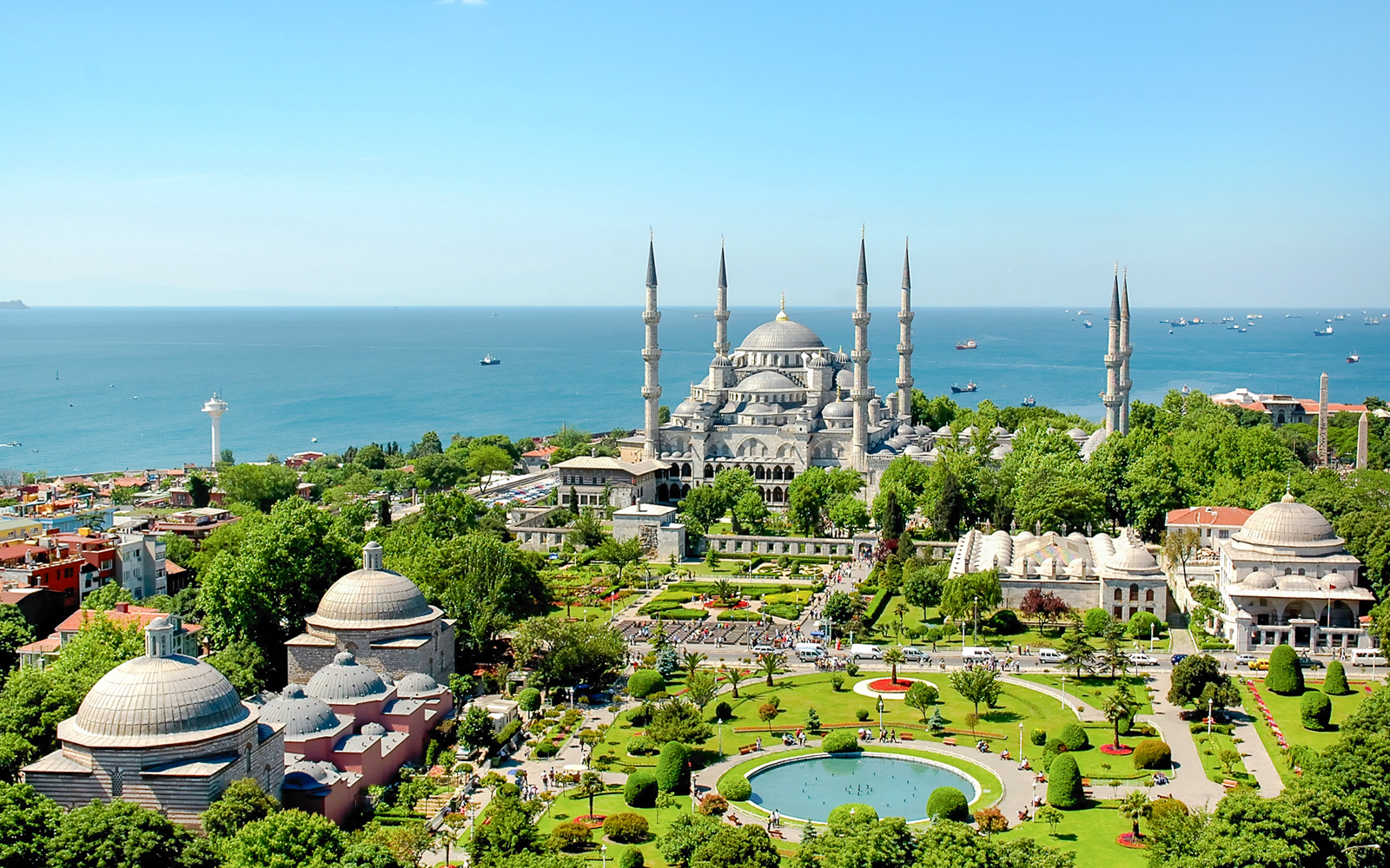 Blue Mosque exterior with gardens and view of the Bosphorus in Istanbul.