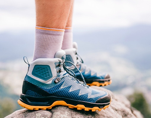 Hiking boots on rocky terrain at Caminito Del Rey, Spain.