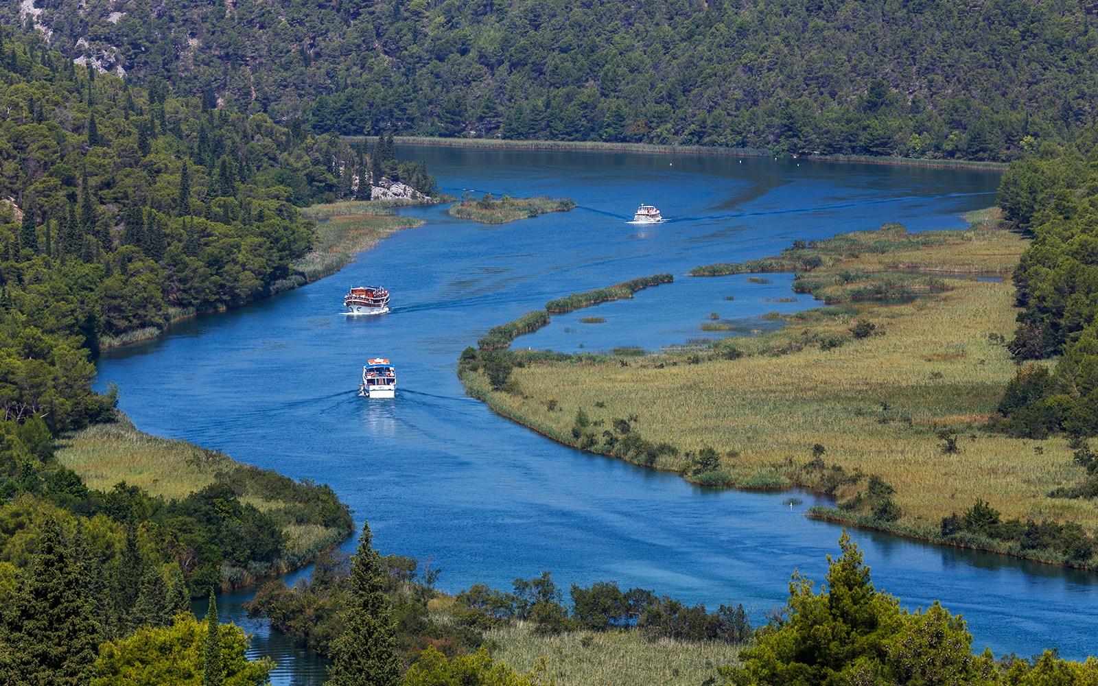 Krka National Park boat tour with view of cascading waterfalls.