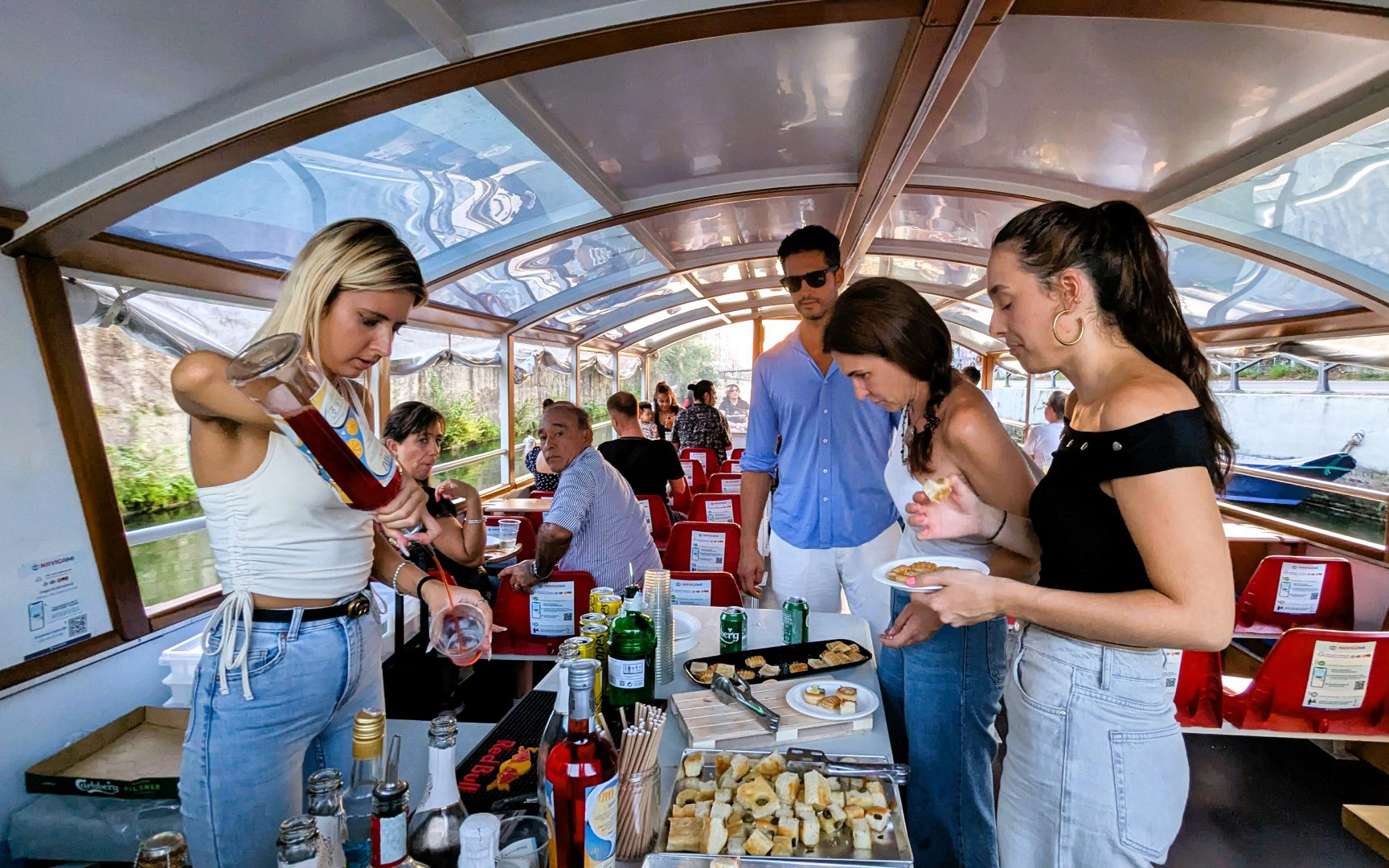 Aperitif drinks and snacks served on a Navigli canal cruise in Milan.
