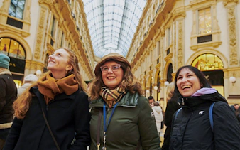 Visitors enjoying the architecture inside Milan's Galleria Vittorio Emanuele II.