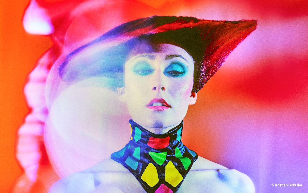 Performer in vibrant costume at BLINDED by DELIGHT Grand Show, Friedrichstadt Palast.