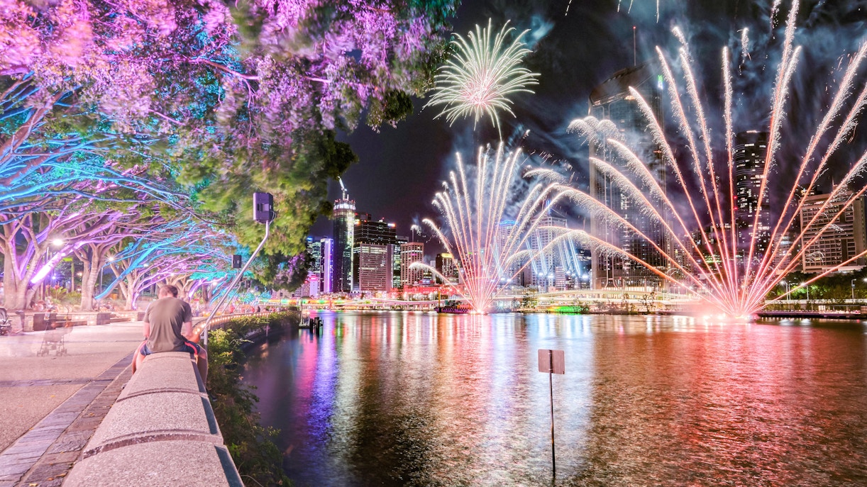 Brisbane Christmas fireworks with colourful trees and people lining the banks of the Brisbane River at Southbank