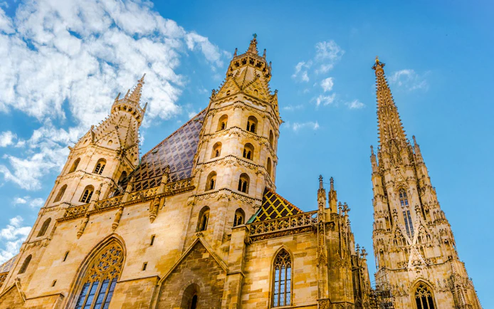St. Stephen's Cathedral towers against a blue sky in Vienna, Austria.