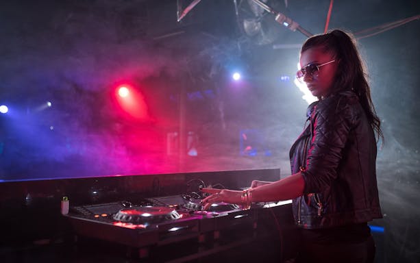 DJ performing at Night Splash event, SplashMania Waterpark.