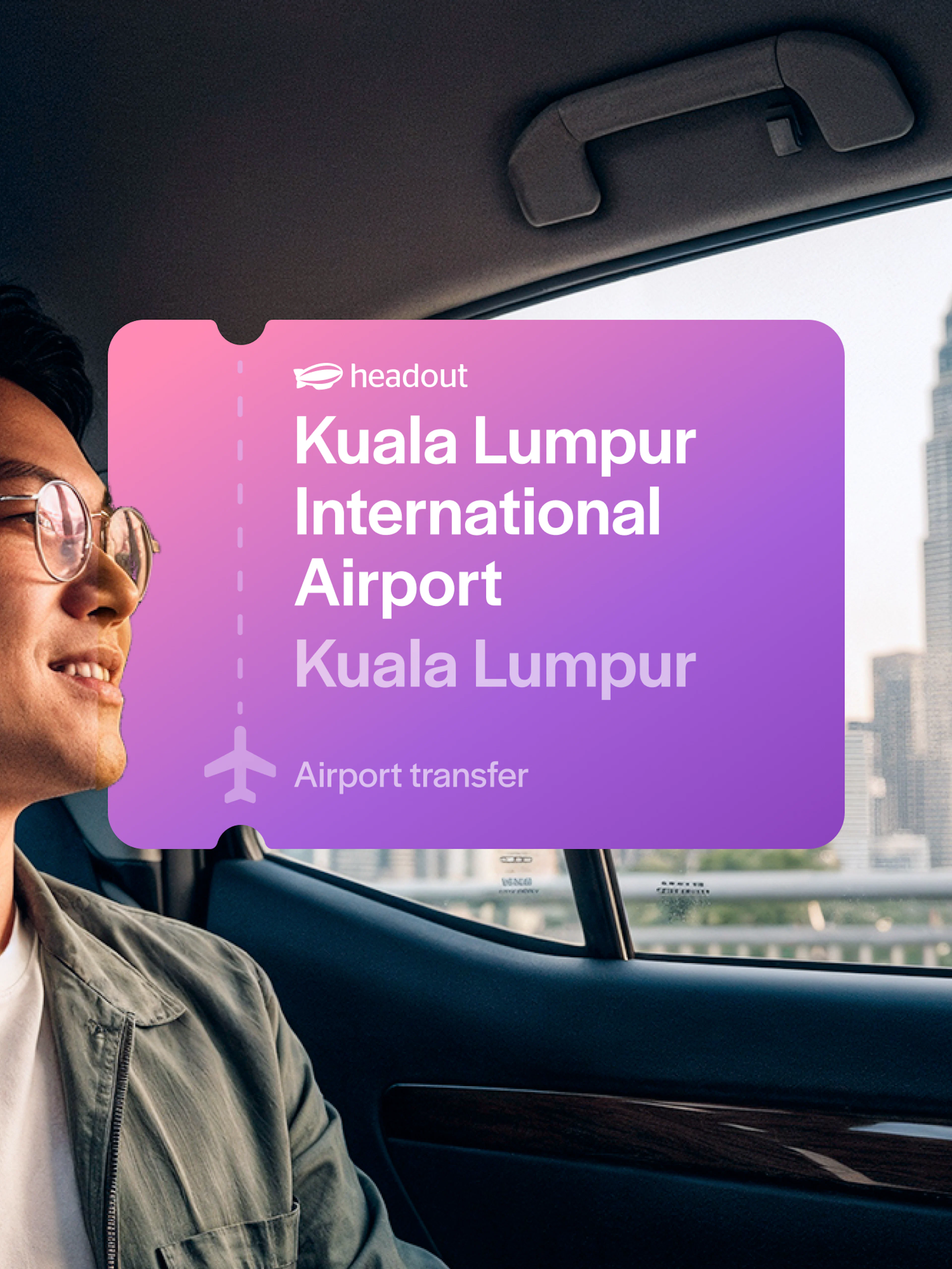 Man in car with view of Petronas Towers, Kuala Lumpur airport transfer.