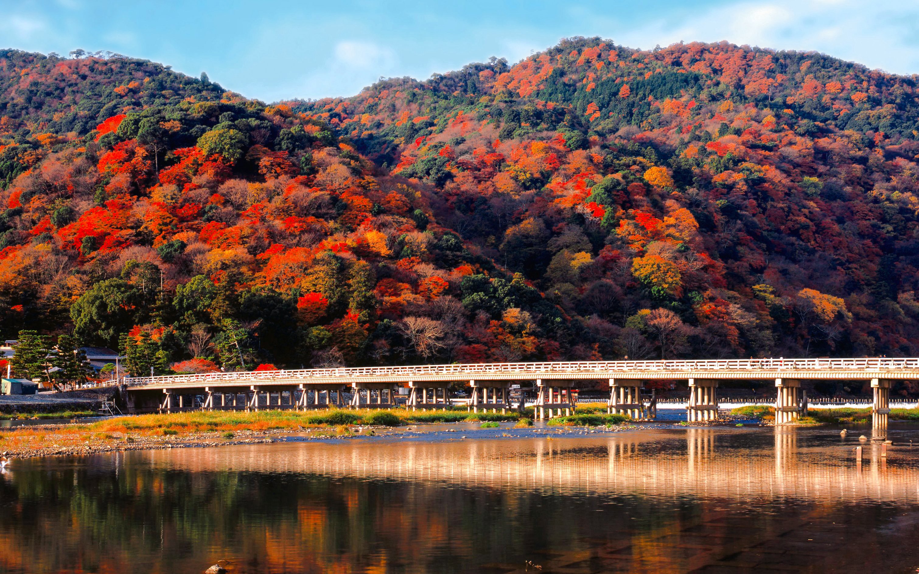 Togetsukyo Bridge with autumn foliage in Arashiyama, Kyoto, Japan.