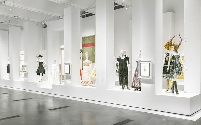 Alexander McQueen exhibition with mannequins in avant-garde fashion at a museum.